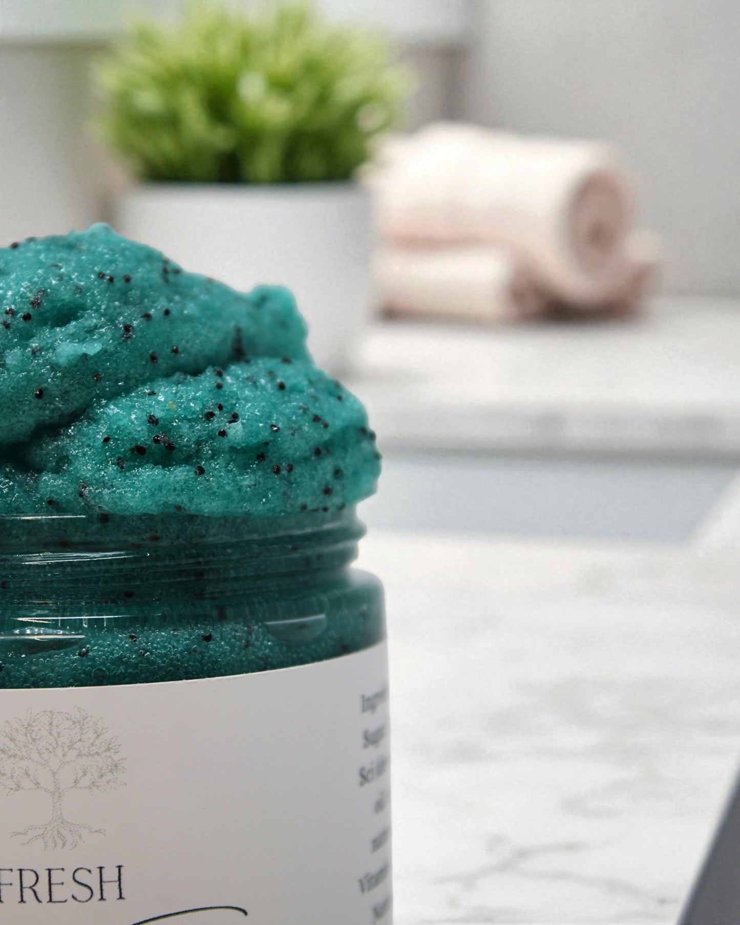 a jar filled with sugar scrub with poppyseeds