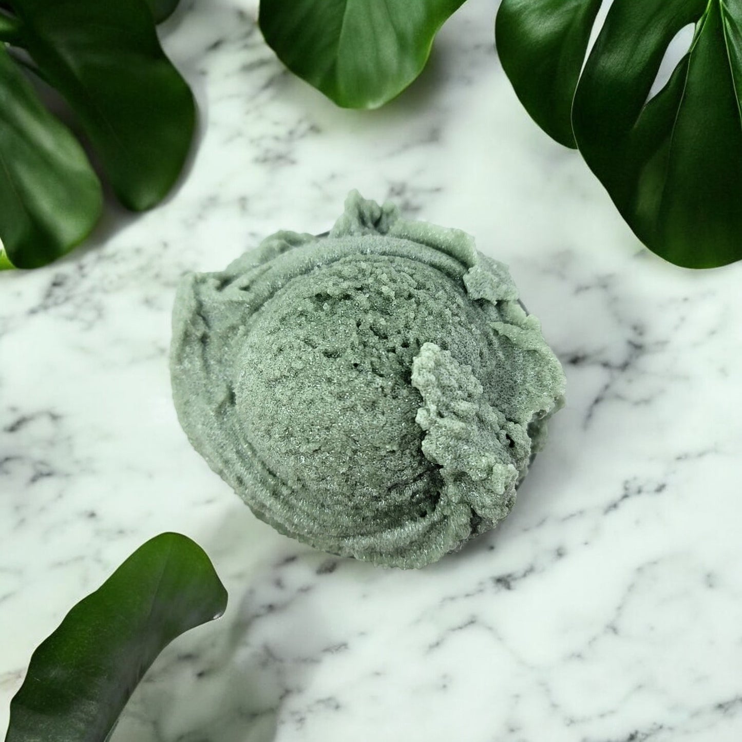a scoop of tea tree essential oil sugar scrub looking like a dreamy scoop of mint ice cream