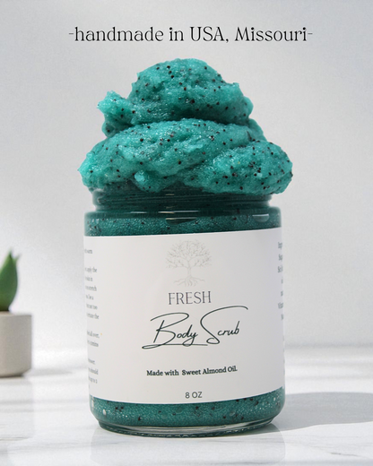 Jar of green body scrub with a white label on a light background